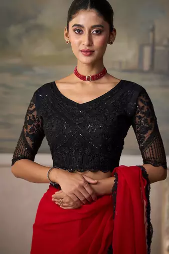 Red faux chiffon saree with black embroidered border and  blouse