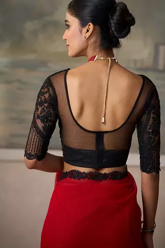 Red faux chiffon saree with black embroidered border and  blouse