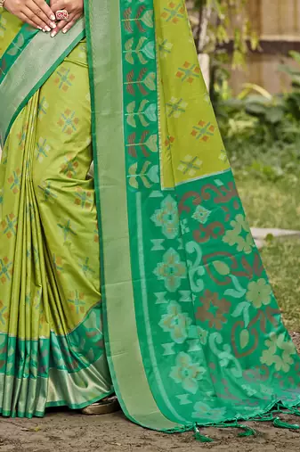 Light green silk blend saree with contrast woven zari border
