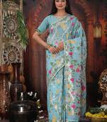 sky blue cotton blend saree with colorful woven floral motifs