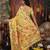 yellow cotton blend saree with colorful woven floral motifs