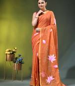 orange mulmul cotton blend saree with lotus bloom print