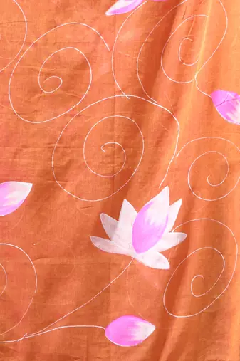 orange mulmul cotton blend saree with lotus bloom print