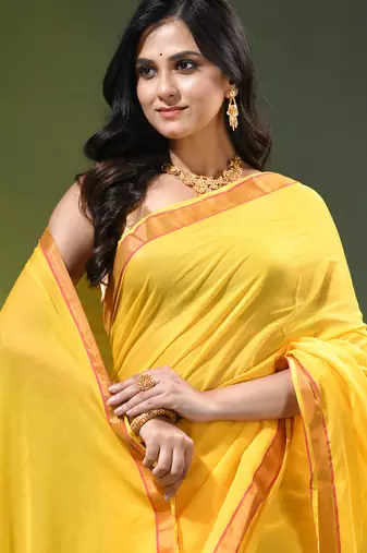 yellow solid mulmul cotton blend saree with contrast border