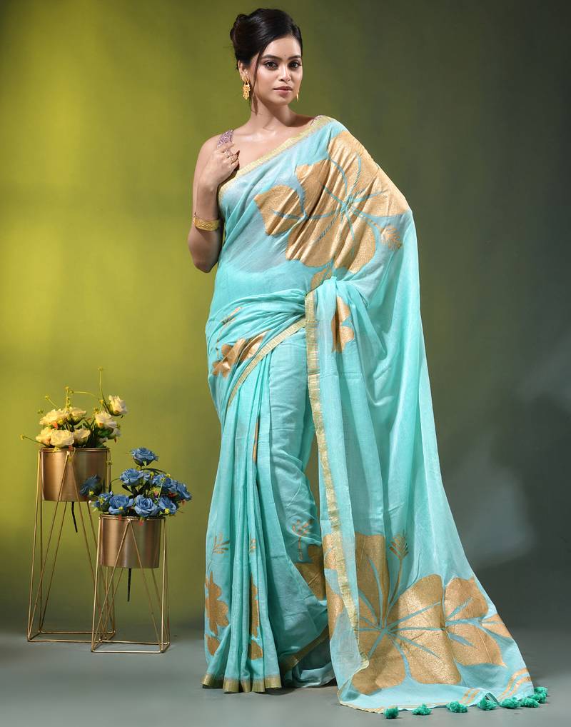 sea green mulmul cotton blend saree with golden hibiscus foil print