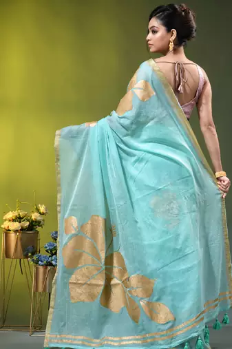 sea green mulmul cotton blend saree with golden hibiscus foil print