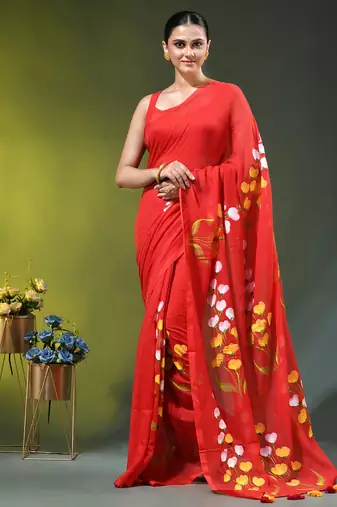 red mulmul saree with painted floral motifs