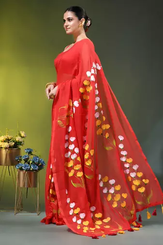 red mulmul saree with painted floral motifs