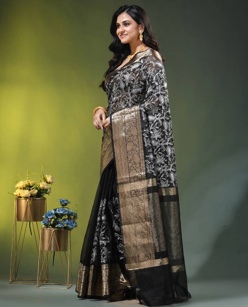 Elegant black organza saree with white floral embroidery & rich golden zari border