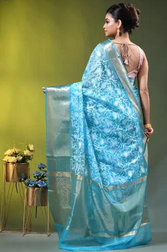 Elegant sky blue organza saree with white floral embroidery & rich golden zari border