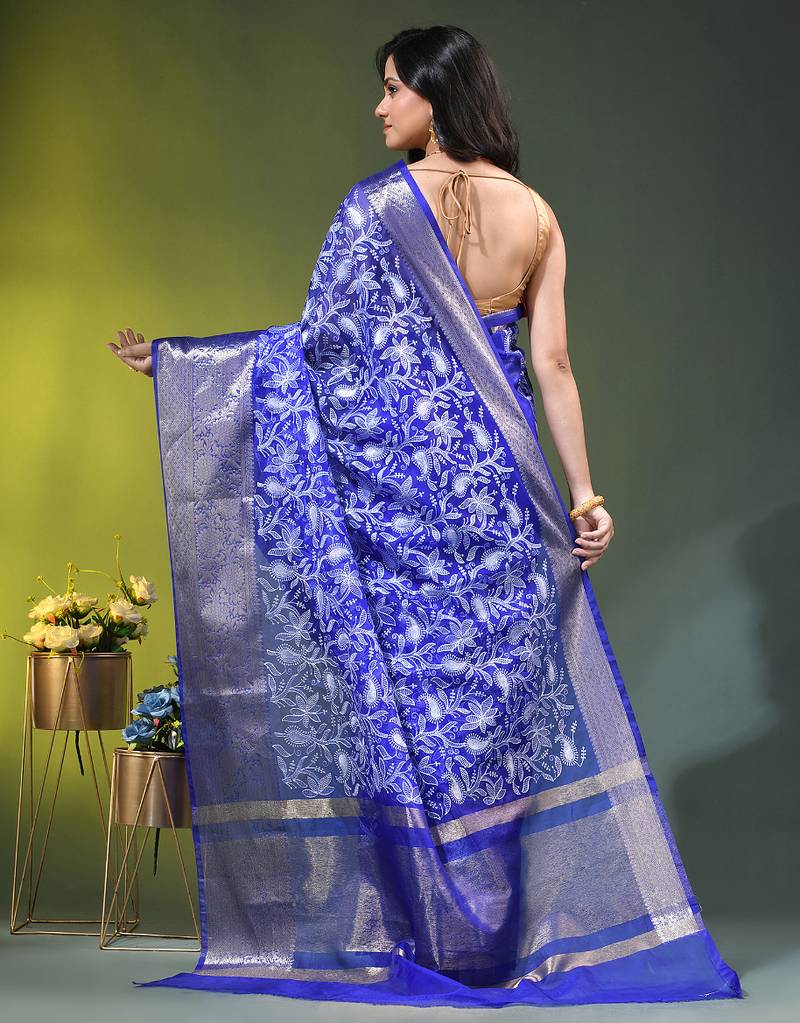 Elegant blue organza saree with white floral embroidery & rich golden zari border