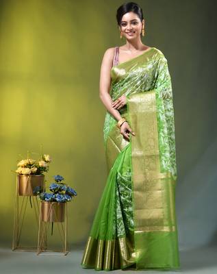 Elegant green organza saree with white floral embroidery & rich golden zari border 1
