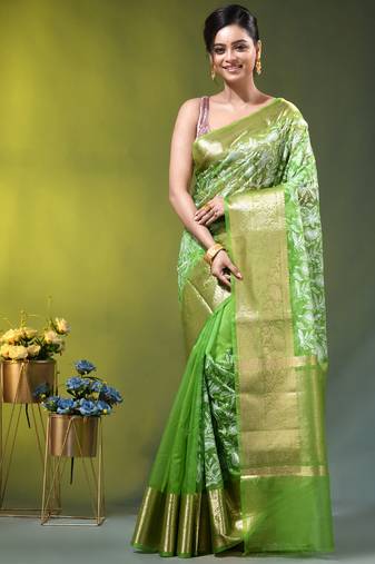 Elegant green organza saree with white floral embroidery & rich golden zari border