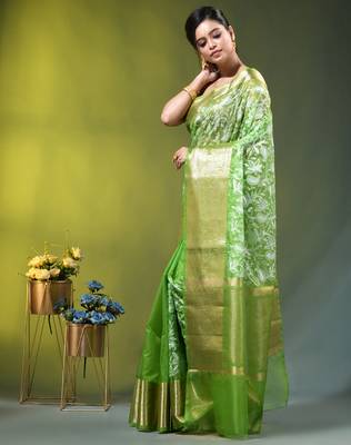 Elegant green organza saree with white floral embroidery & rich golden zari border 2