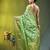Elegant green organza saree with white floral embroidery & rich golden zari border
