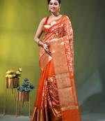 Elegant orange organza saree with white floral embroidery & rich golden zari border