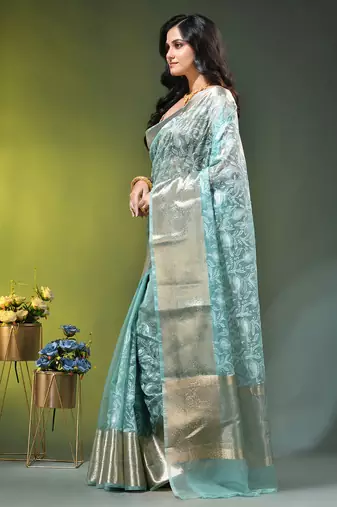 Elegant mint green organza saree with white floral embroidery & rich golden zari border