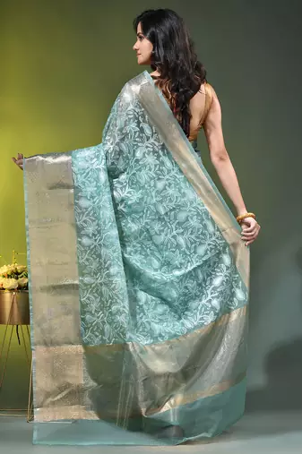 Elegant mint green organza saree with white floral embroidery & rich golden zari border