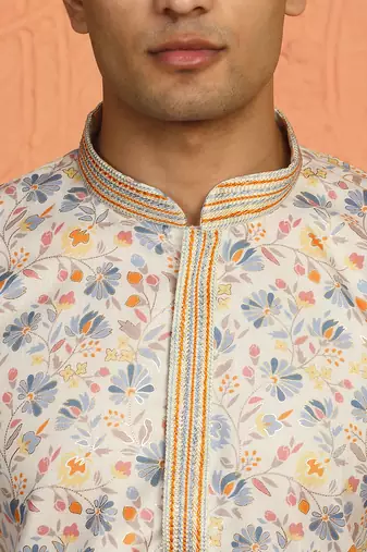 cream kurta featuring intricate floral patterns and mandarin collar