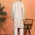 cream kurta featuring intricate floral patterns and mandarin collar
