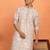 beige kurta featuring intricate floral patterns and mandarin collar