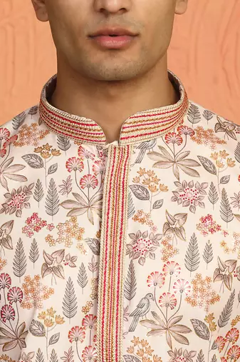 beige kurta featuring intricate floral patterns and mandarin collar