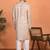 beige kurta featuring intricate floral patterns and mandarin collar