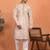beige kurta featuring intricate floral patterns and mandarin collar