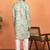 green kurta featuring intricate floral patterns and mandarin collar