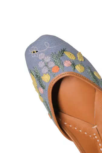 Blue denim juttis with quirk of floral embroidery
