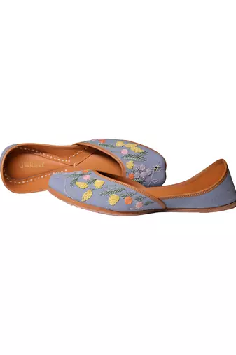Blue denim juttis with quirk of floral embroidery