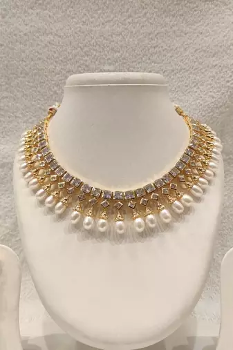 Certified natural freshwater pearls jewellery gold-toned kundan choker necklace and earrings set with pearl drops.