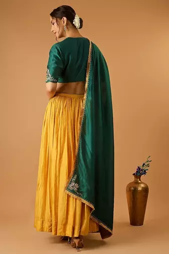 Green embroidered blouse with yellow flared lehenga with embroidered dupatta