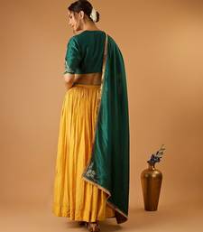 Green embroidered blouse with yellow flared lehenga with embroidered dupatta