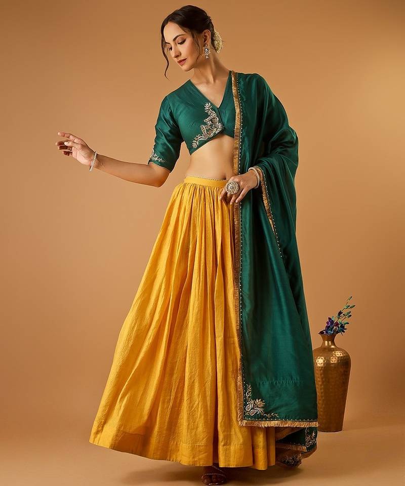 Green embroidered blouse with yellow flared lehenga with embroidered dupatta