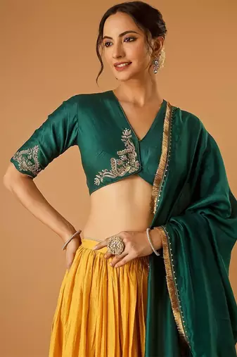 Green embroidered blouse with yellow flared lehenga with embroidered dupatta