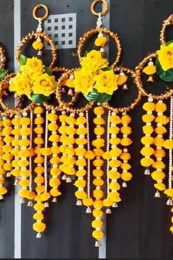 handmade yellow pompom floral ring hanging toran with bellsfestive hanging for home decor (pack of 2)
