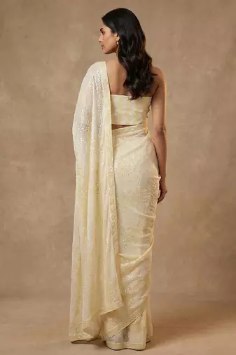 Yellow embroidered georgette saree with unstitched blouse