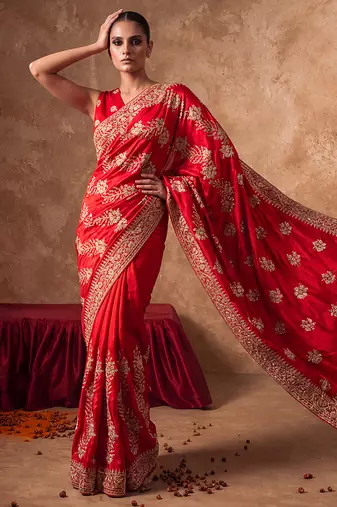 Red embroidered silk saree with unstitched blouse
