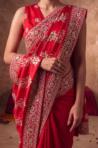 Red embroidered silk saree with unstitched blouse
