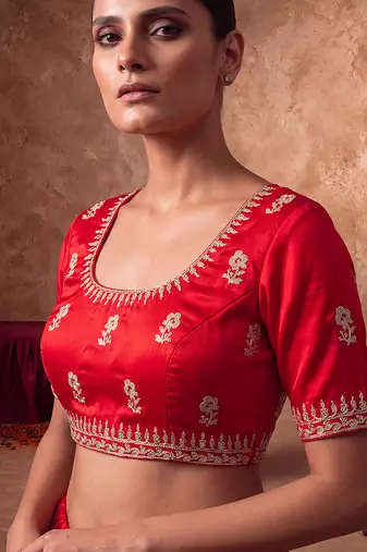 Red embroidered silk saree with unstitched blouse