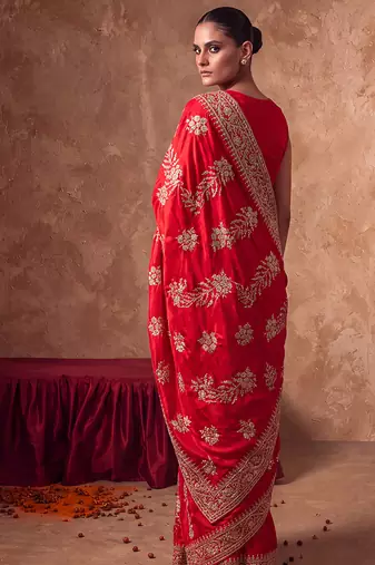 Red embroidered silk saree with unstitched blouse