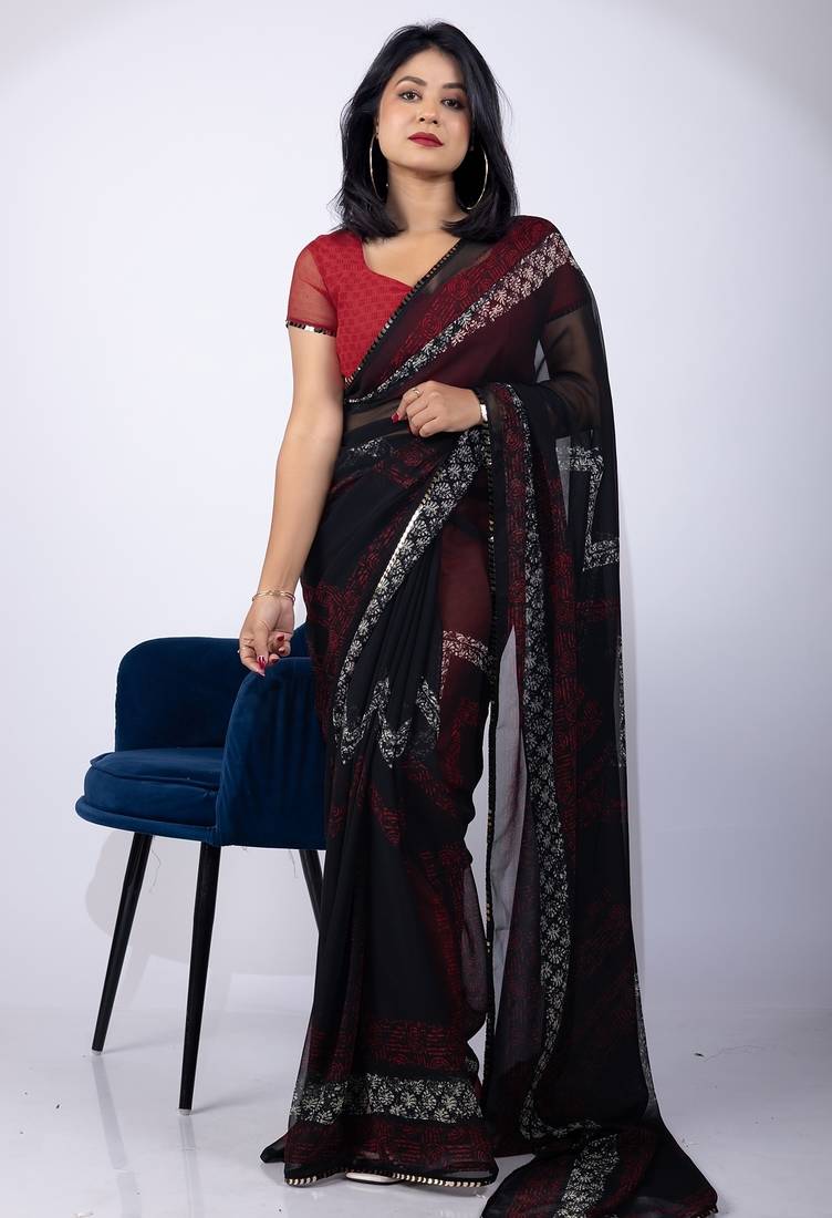 Women's black chevron print georgette saree with unstitched piece