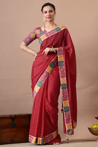 Women's red embellished georgette saree with unstitched piece