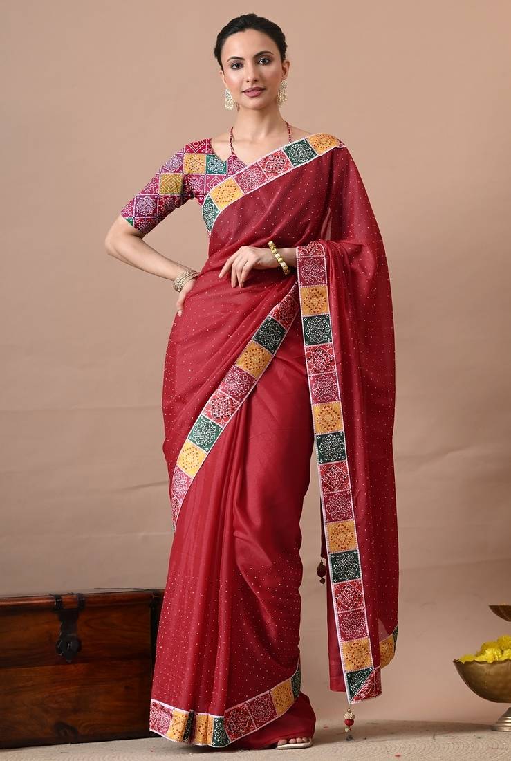 Women's red embellished georgette saree with unstitched piece
