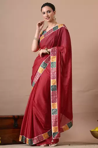 Women's red embellished georgette saree with unstitched piece