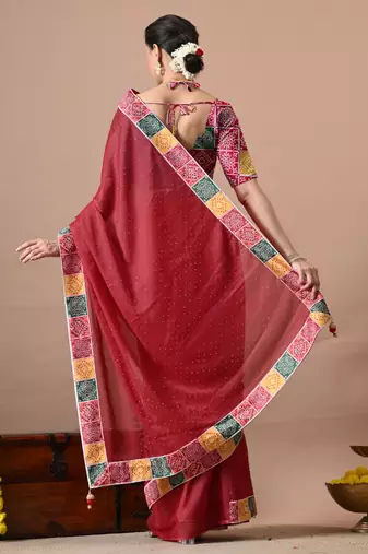 Women's red embellished georgette saree with unstitched piece