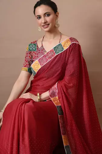Women's red embellished georgette saree with unstitched piece