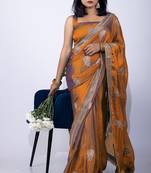Women's orange embellished soft silk blend saree with unstitched piece