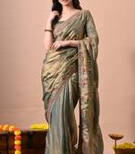 Women's green embellished soft silk blend saree with unstitched piece
